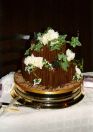 Chocolate “log style” wedding cake. With 3 scotties dotted amongst the foliage